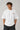Model wearing a white POP-FROM-THE-NORTH oversized t-shirt with a small red logo on the chest, styled with black cargo pants, showcasing a relaxed streetwear fit.