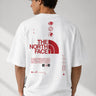 Model wearing a white POP-FROM-THE-NORTH oversized t-shirt with a small red logo on the chest, styled with black cargo pants, showcasing a relaxed streetwear fit. - white