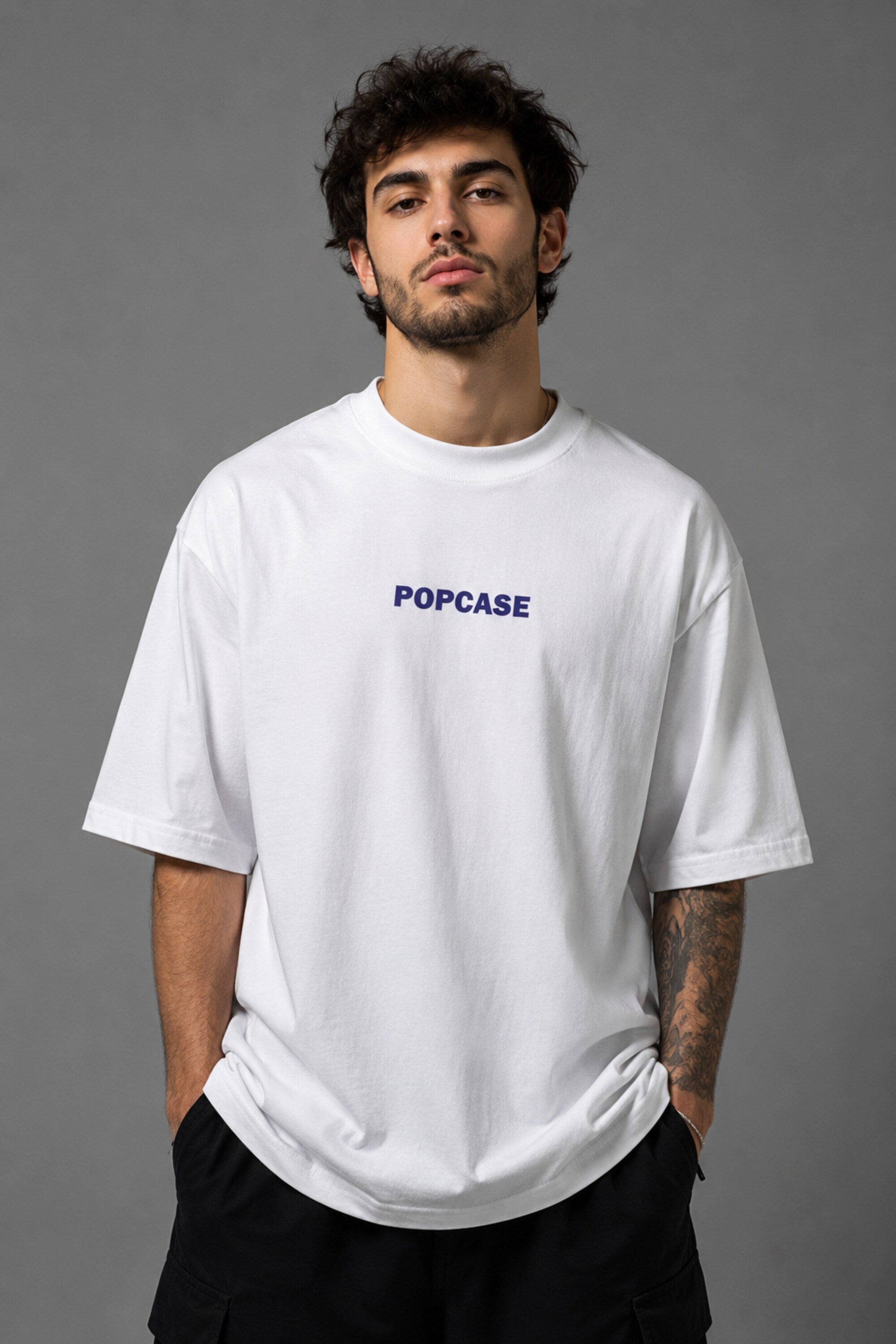 White POPCASE oversized tshirt with i'm not cristiano ronaldo but i also hate losing quote in navy on back, POPCASE Since 2022 tagline