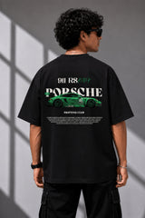 Beige oversized t-shirt featuring a vibrant green Porsche 911 RS RAWK graphic and 'Drifting Club' text. Mockup highlighting premium cotton fabric and stitching details.