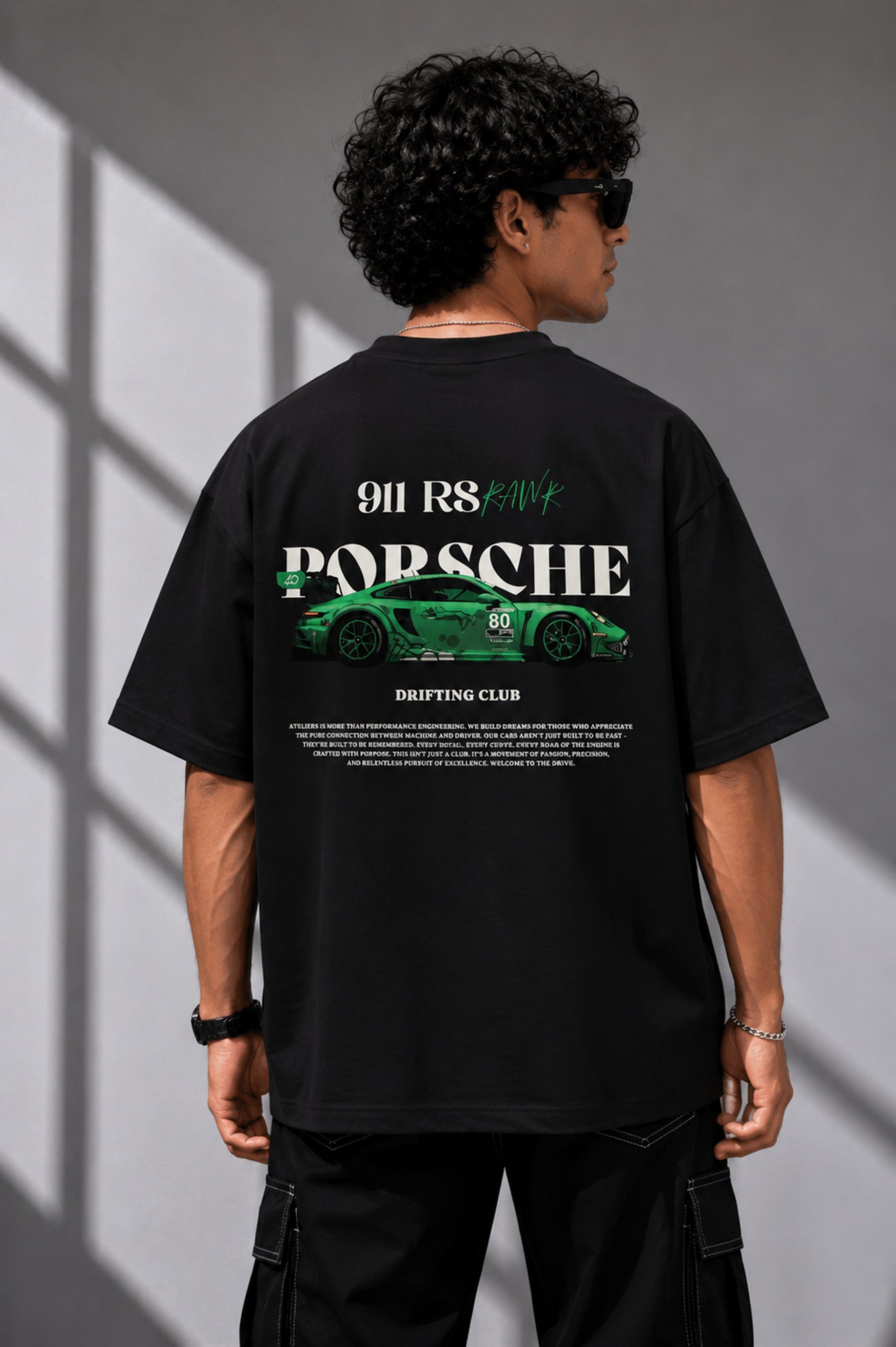 Beige oversized t-shirt featuring a vibrant green Porsche 911 RS RAWK graphic and 'Drifting Club' text. Mockup highlighting premium cotton fabric and stitching details.