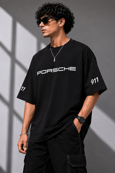 Beige oversized t-shirt featuring a vibrant green Porsche 911 RS RAWK graphic and 'Drifting Club' text. Mockup highlighting premium cotton fabric and stitching details.