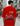 Person wearing a red t-shirt with a graphic design on the back in an urban setting