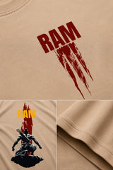 Model wearing a beige RAM oversized t-shirt with a red graphic print on the chest, paired with dark trousers and white sneakers. Showcases streetwear style and premium comfort.