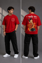 Man wearing a white RAM YODHA oversized t-shirt with 'Ram' graphic on front and Ram Yoddha artwork on back, seated on wooden steps. - red