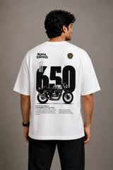 Man wearing a white oversized Royal Enfield t-shirt with a classic cannon graphic. Features a relaxed fit and modern streetwear aesthetic.