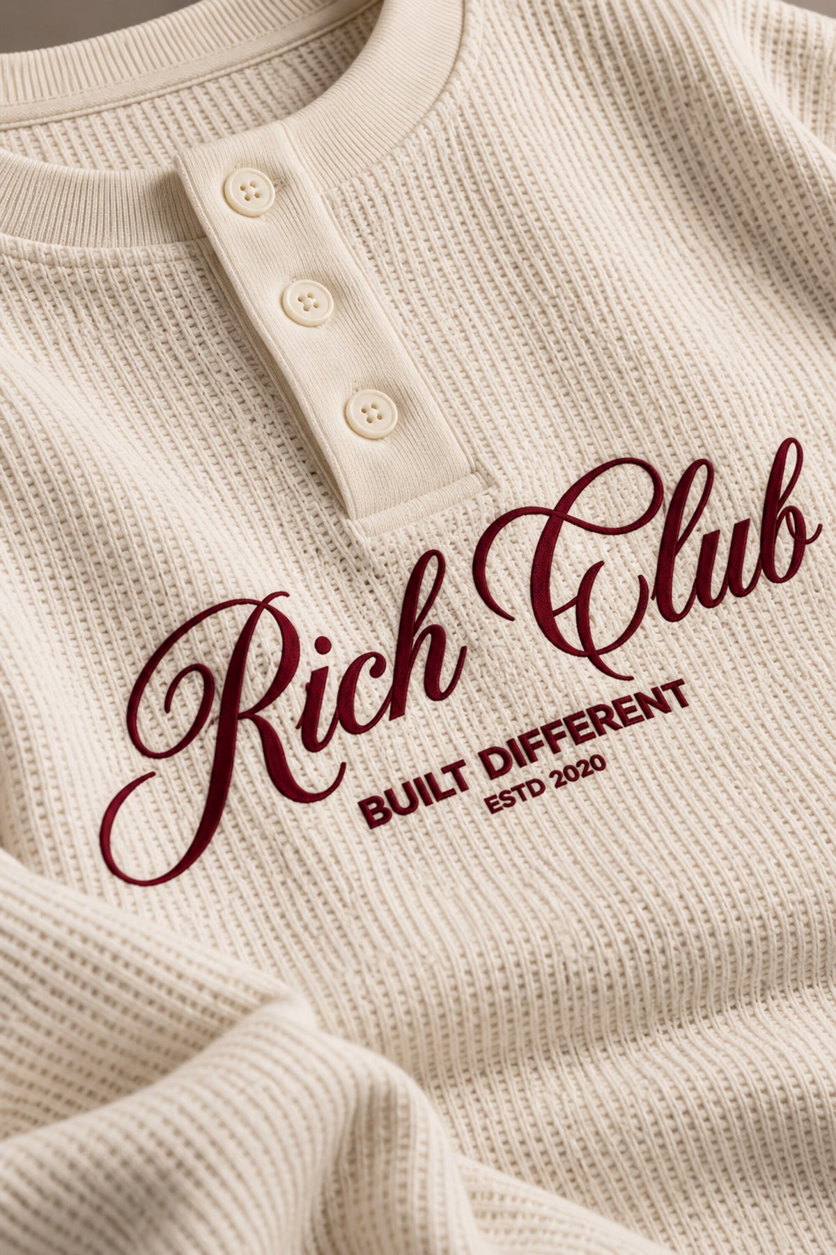 Cream waffle full sleeve boxy tshirt with Rich Club red cursive script print on chest, henley collar, men India