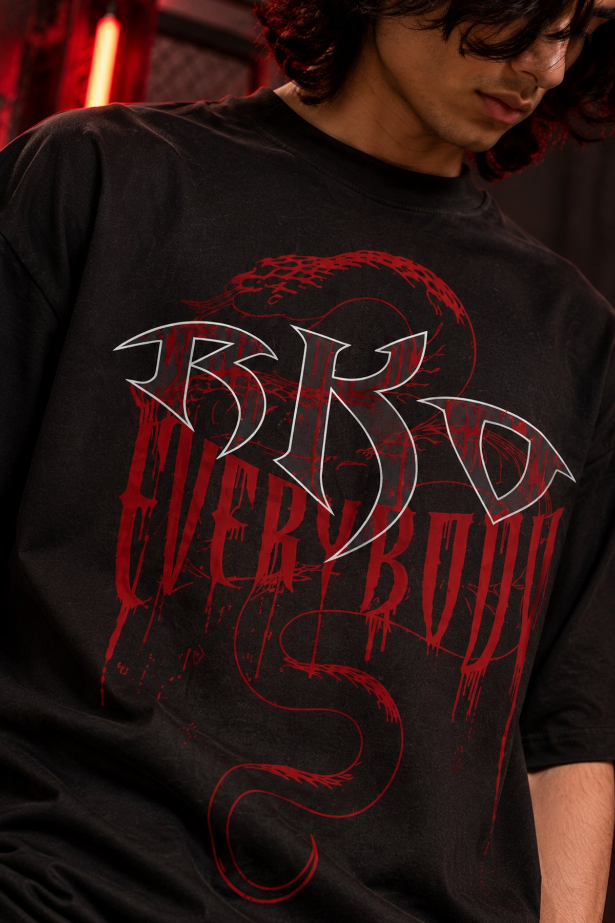 Black oversized tshirt with RKO white logo and Everybody dark red gothic text and snake on front, drop shoulder boxy fit, men India
