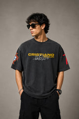 Model wearing a vintage wash dark blue oversized t-shirt with a graphic of Cristiano Ronaldo on the back and "CRISTIANO RONALDO" text on the front. - anthracite black