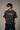 Model wearing a vintage wash dark blue oversized t-shirt with a graphic of Cristiano Ronaldo on the back and "CRISTIANO RONALDO" text on the front. - anthracite black