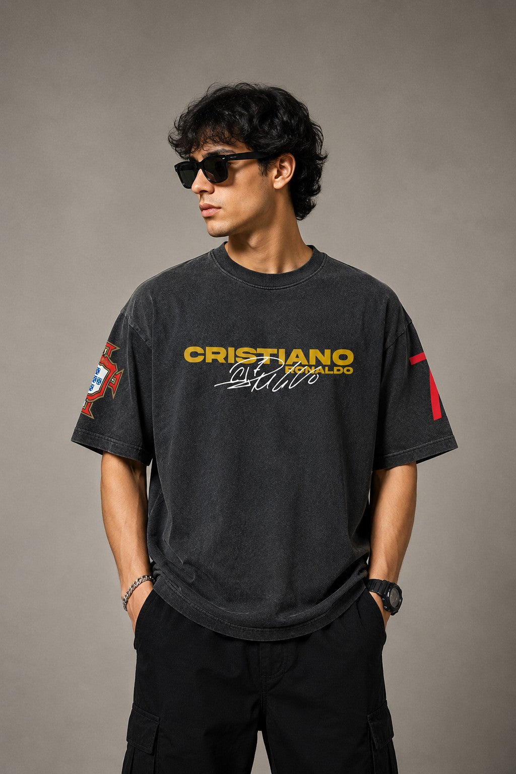 Model wearing a vintage wash dark blue oversized t-shirt with a graphic of Cristiano Ronaldo on the back and "CRISTIANO RONALDO" text on the front. - anthracite black