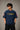 Model wearing a vintage wash dark blue oversized t-shirt with a graphic of Cristiano Ronaldo on the back and "CRISTIANO RONALDO" text on the front. - midnight indigo