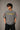 Model wearing a vintage wash dark blue oversized t-shirt with a graphic of Cristiano Ronaldo on the back and "CRISTIANO RONALDO" text on the front. - stone grey