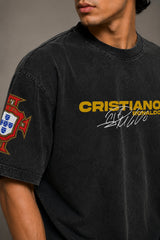 Model wearing a vintage wash dark blue oversized t-shirt with a graphic of Cristiano Ronaldo on the back and "CRISTIANO RONALDO" text on the front.