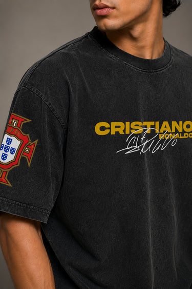 Model wearing a vintage wash dark blue oversized t-shirt with a graphic of Cristiano Ronaldo on the back and "CRISTIANO RONALDO" text on the front.