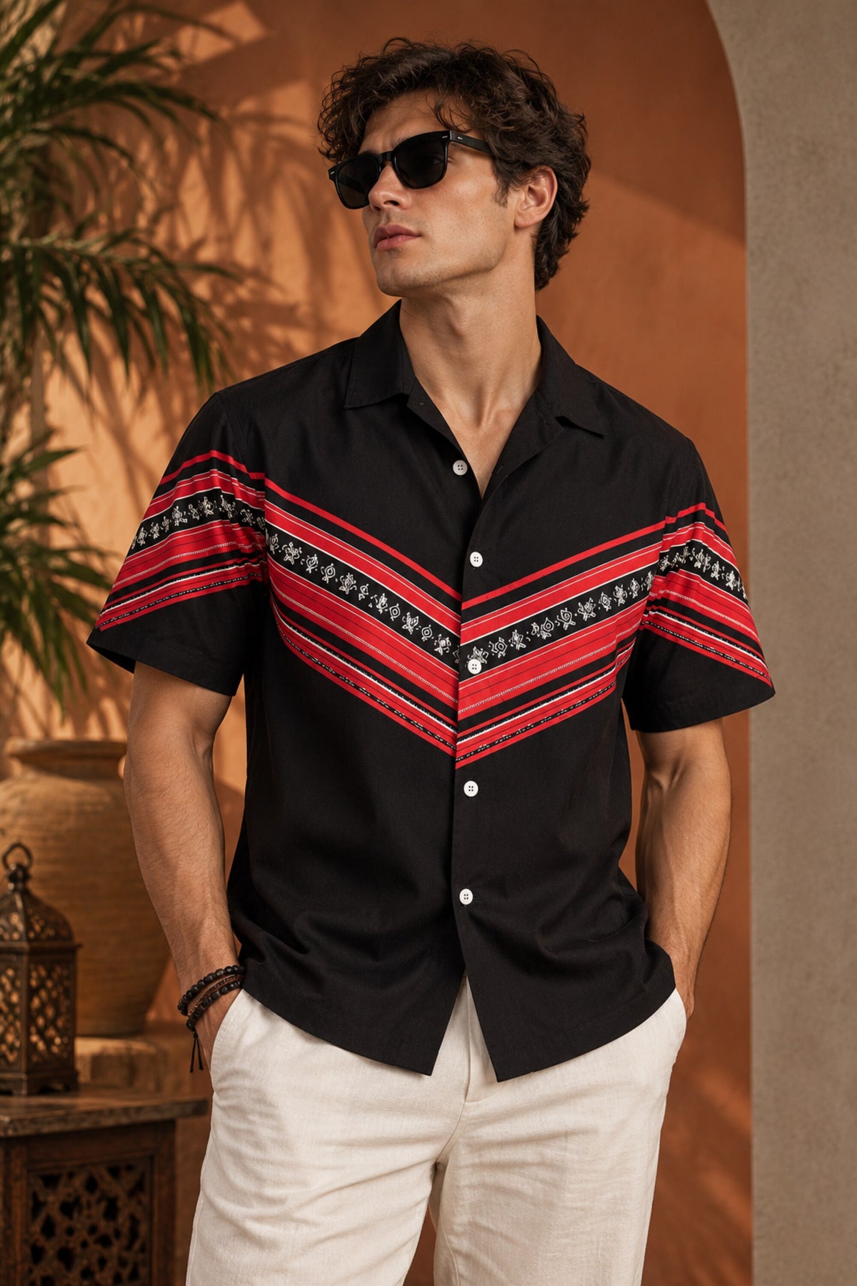 Black Hawaiian shirt with bold red tribal folk art chevron stripe print across chest and sleeves, Cuban collar, men India