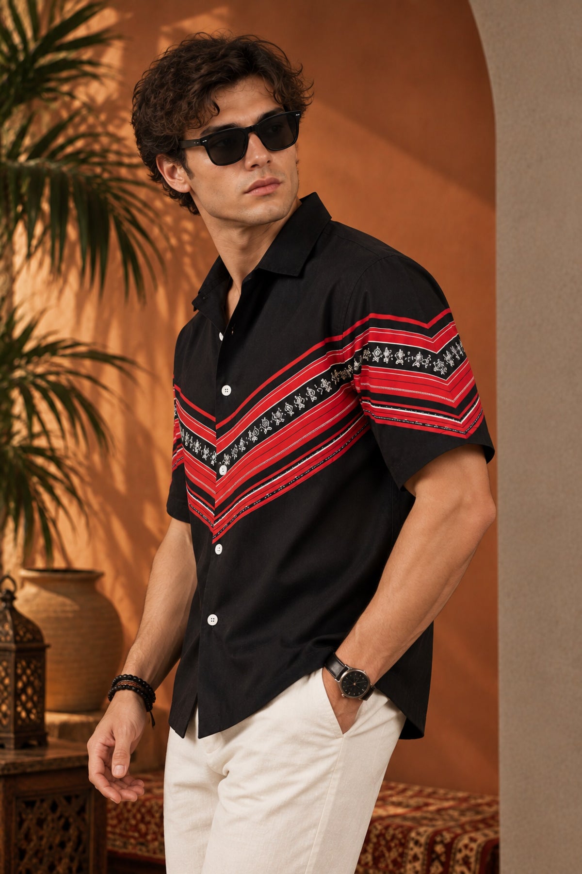 Black Hawaiian shirt with bold red tribal folk art chevron stripe print across chest and sleeves, Cuban collar, men India