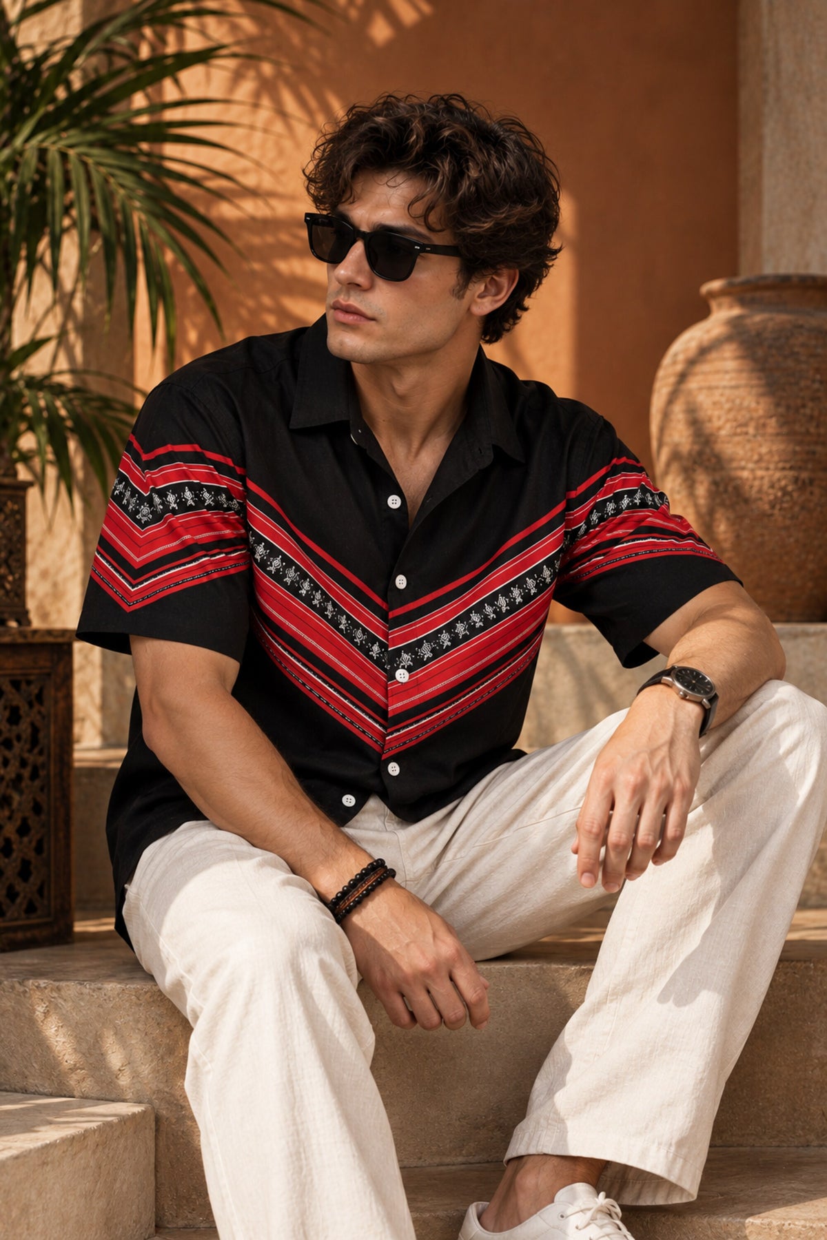 Black Hawaiian shirt with bold red tribal folk art chevron stripe print across chest and sleeves, Cuban collar, men India