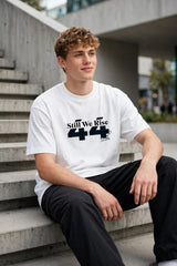 Model wearing white POPCASE Sir Lewis Hamilton oversized t shirt with Still We Rise 44 graphic and signature on chest