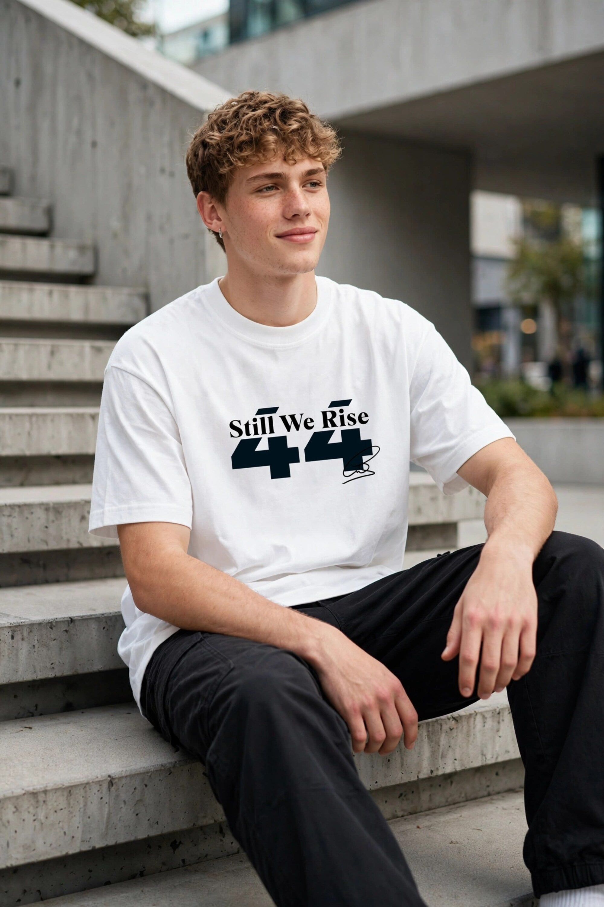 Model wearing white POPCASE Sir Lewis Hamilton oversized t shirt with Still We Rise 44 graphic and signature on chest