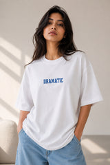 White oversized t-shirt with bold blue DRAMATIC varsity block text front print 220 GSM HD print oversized fit