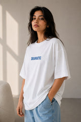 White oversized t-shirt with bold blue DRAMATIC varsity block text front print 220 GSM HD print oversized fit