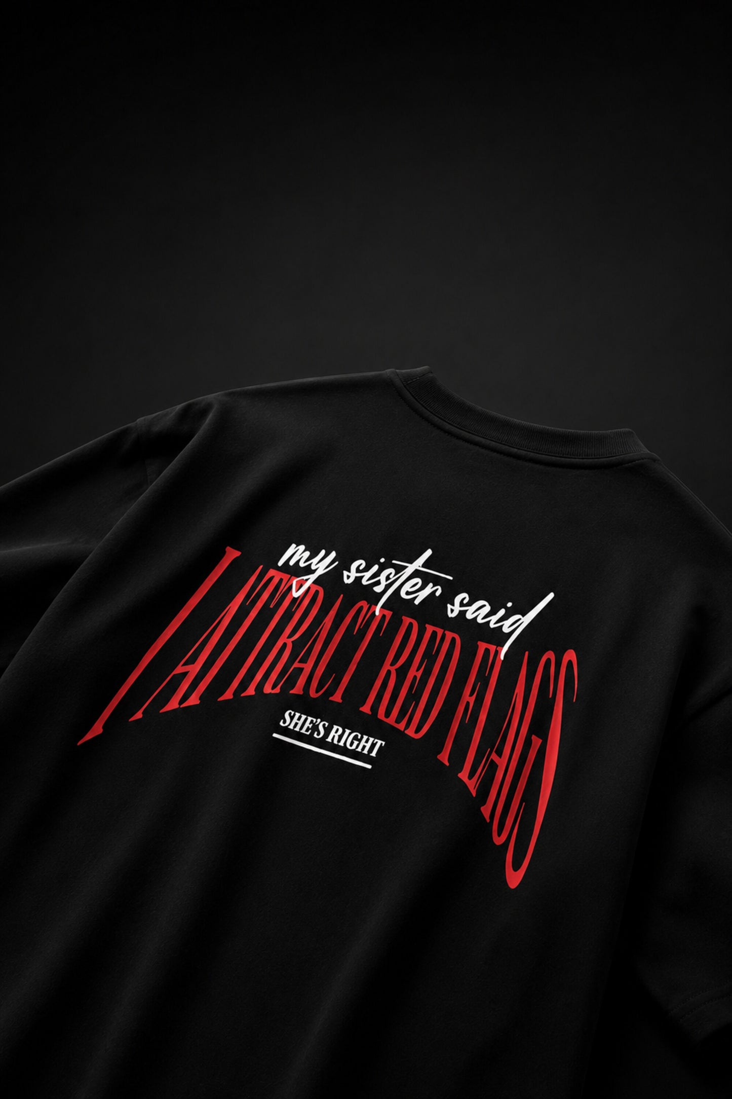 Black oversized t-shirt with my sister said I attract red flags she's right back print in red and white gothic arch text