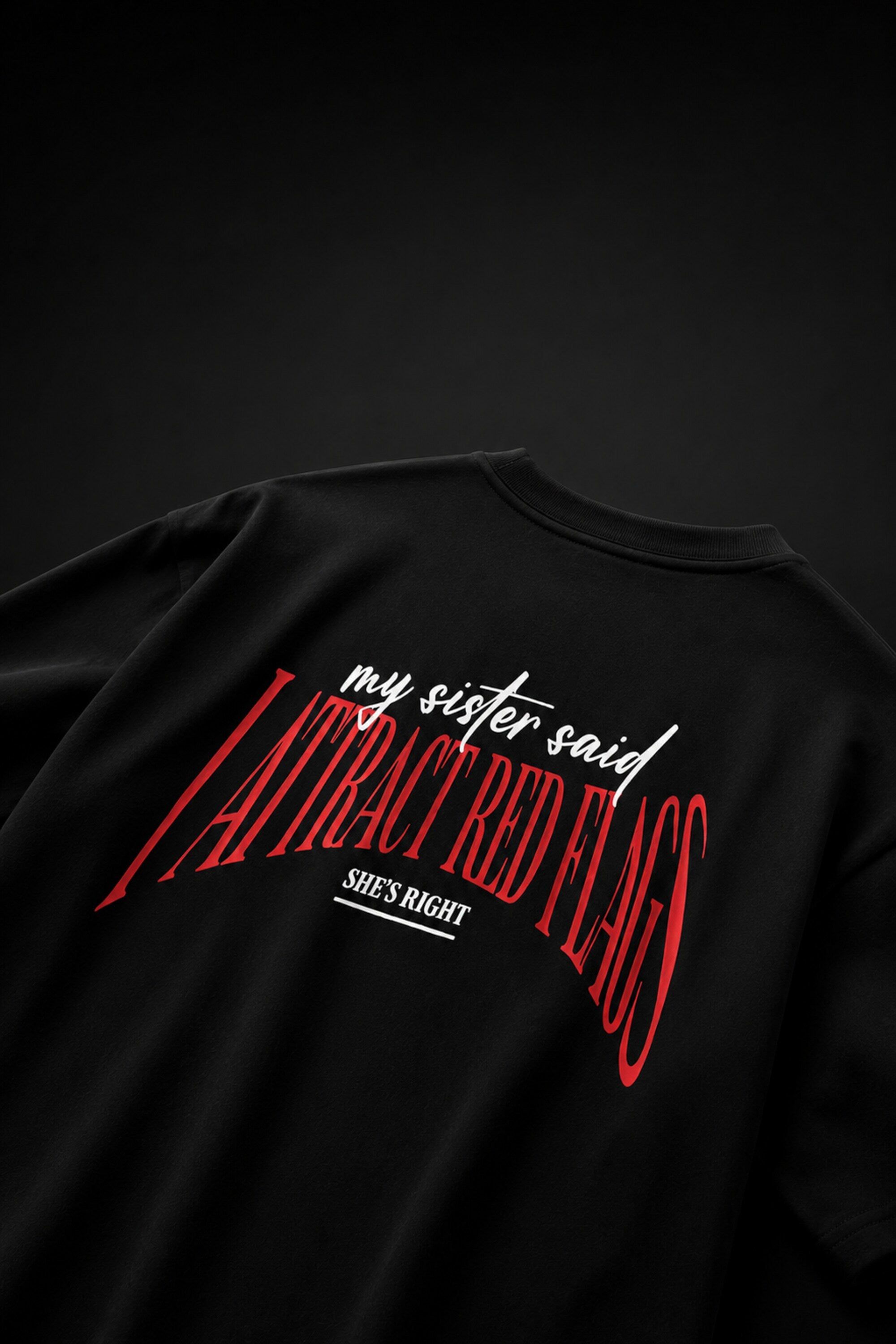 Black oversized t-shirt with my sister said I attract red flags she's right back print in red and white gothic arch text