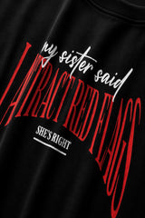 Black oversized t-shirt with my sister said I attract red flags she's right back print in red and white gothic arch text
