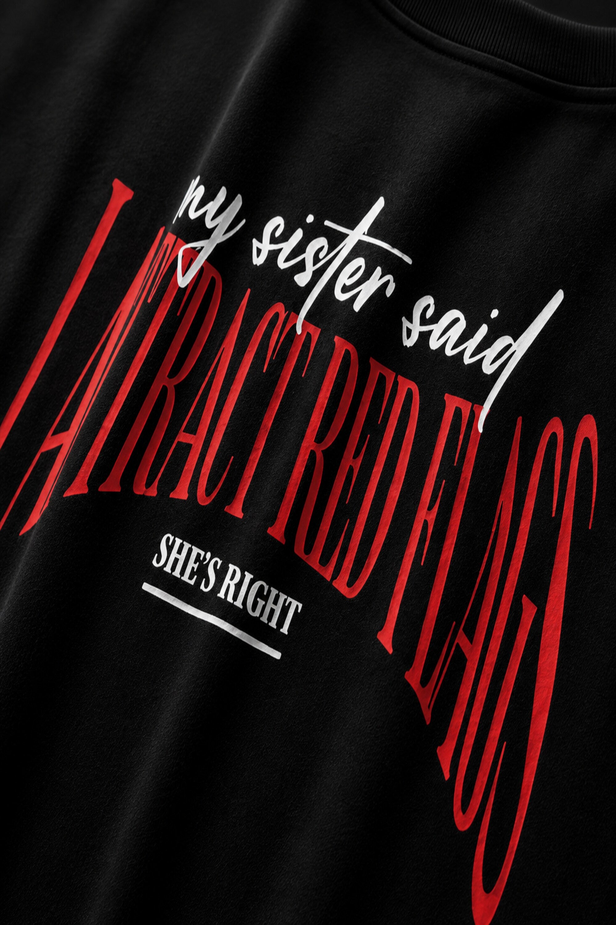 Black oversized t-shirt with my sister said I attract red flags she's right back print in red and white gothic arch text