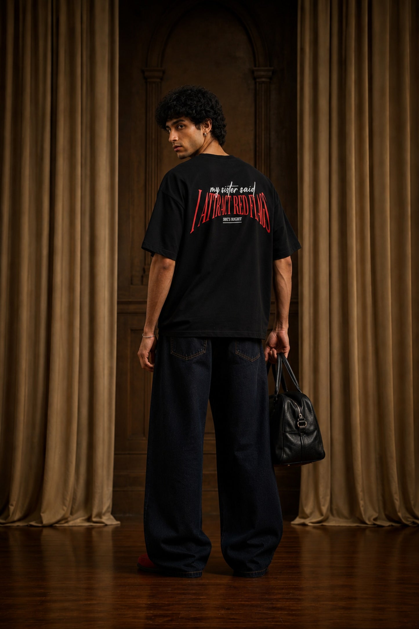 Black oversized t-shirt with my sister said I attract red flags she's right back print in red and white gothic arch text