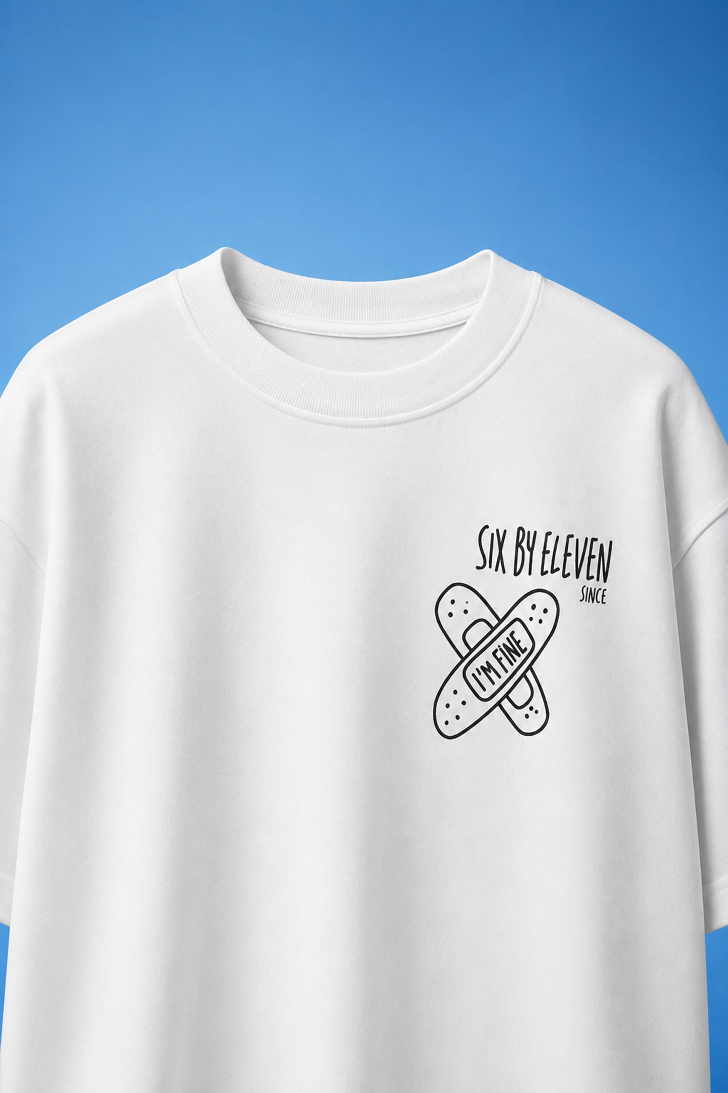 White oversized t-shirt with cute cartoon bunny peeking through sky blue window frame back print