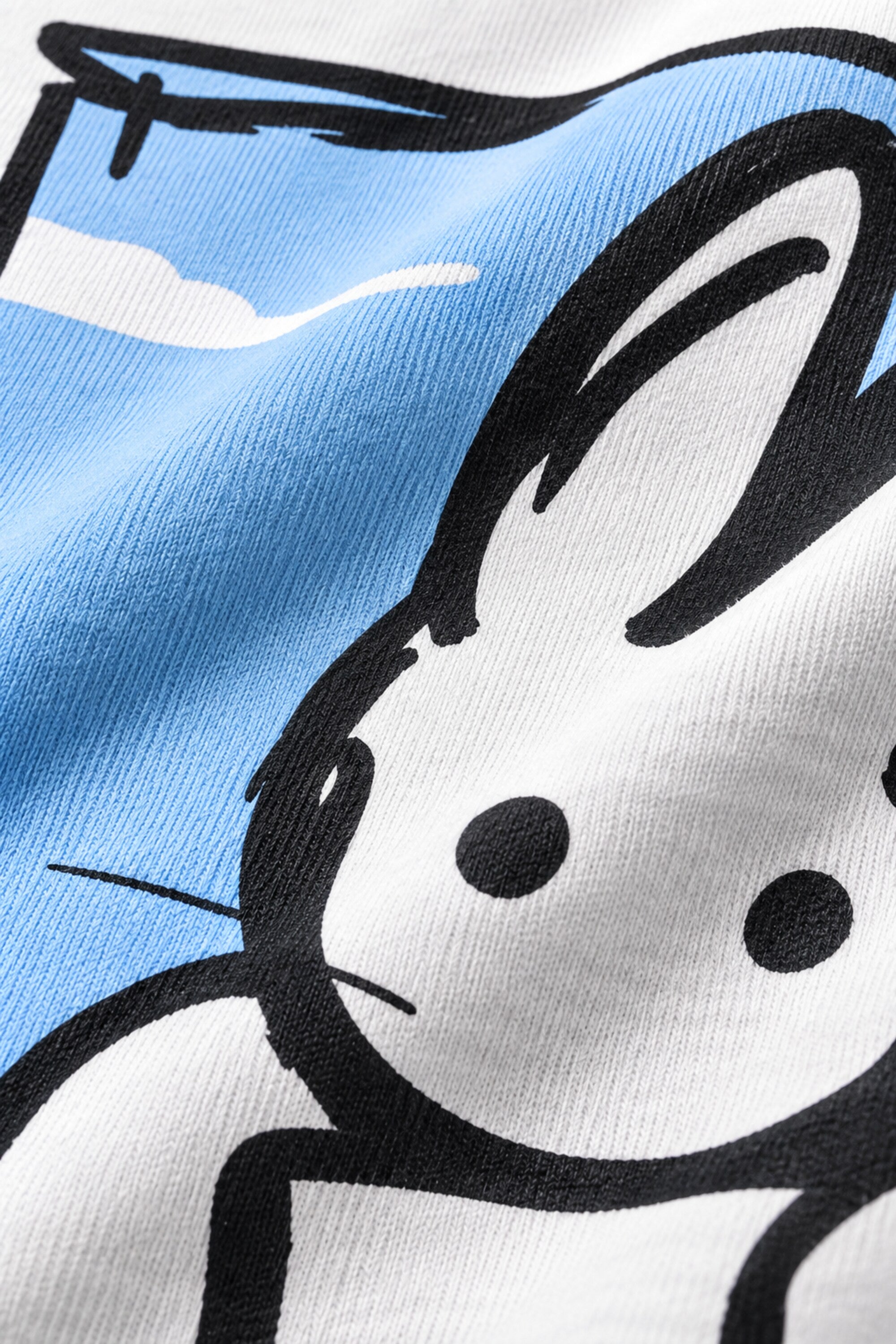White oversized t-shirt with cute cartoon bunny peeking through sky blue window frame back print