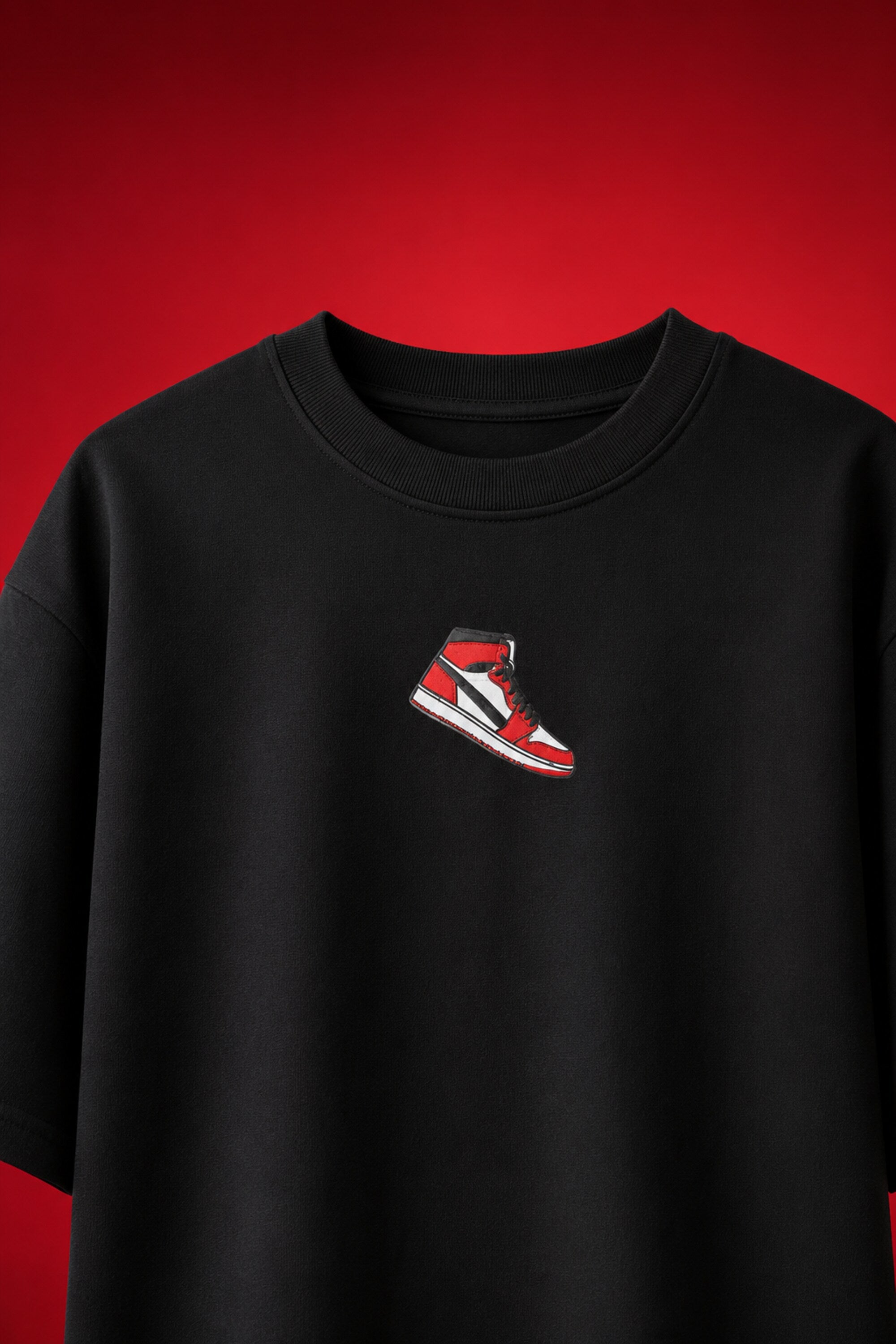 Black oversized t-shirt with Air Jordan 1 Bred sneaker chest graphic illustration