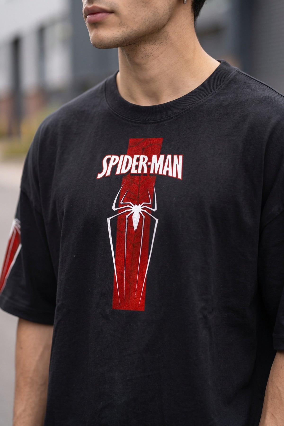 Black oversized tshirt with SPIDER-MAN text and red spider cross icon on chest and red sleeve panels, drop shoulder boxy fit, men India