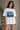 Person wearing a white t-shirt with 'The Starry Night' design by Vincent van Gogh.