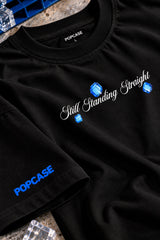 Black oversized tshirt with Still Standing Straight white cursive script and blue accent on chest, drop shoulder boxy fit, men India