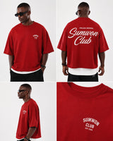 Man wearing a red Sumwon Club oversized t-shirt with white graphic print on front and back, styled for streetwear.