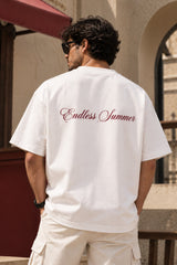 White oversized tshirt with THECOUTURECLUB dark maroon text and Endless Summer cursive print on chest, drop shoulder boxy fit, men India