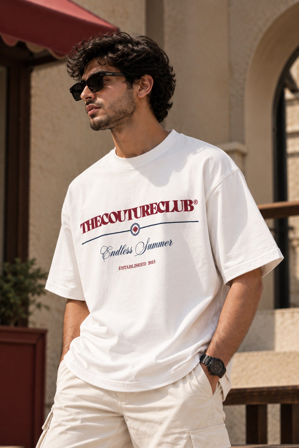 White oversized tshirt with THECOUTURECLUB dark maroon text and Endless Summer cursive print on chest, drop shoulder boxy fit, men India