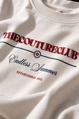 White oversized tshirt with THECOUTURECLUB dark maroon text and Endless Summer cursive print on chest, drop shoulder boxy fit, men India