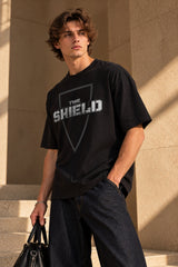 Black oversized tshirt with The Shield badge logo in dark minimal print on front, drop shoulder boxy fit, men India