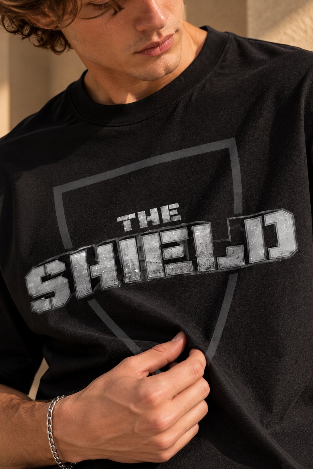 Black oversized tshirt with The Shield badge logo in dark minimal print on front, drop shoulder boxy fit, men India