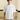 Person wearing a CSK white t-shirt with a small logo on a neutral background