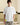 Person wearing a CSK white t-shirt with a small logo on a neutral background