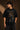 Back view of a man wearing a black UNBREAKABLE TIGER oversized t-shirt, featuring a subtle tonal logo on the upper back. Streetwear aesthetic.