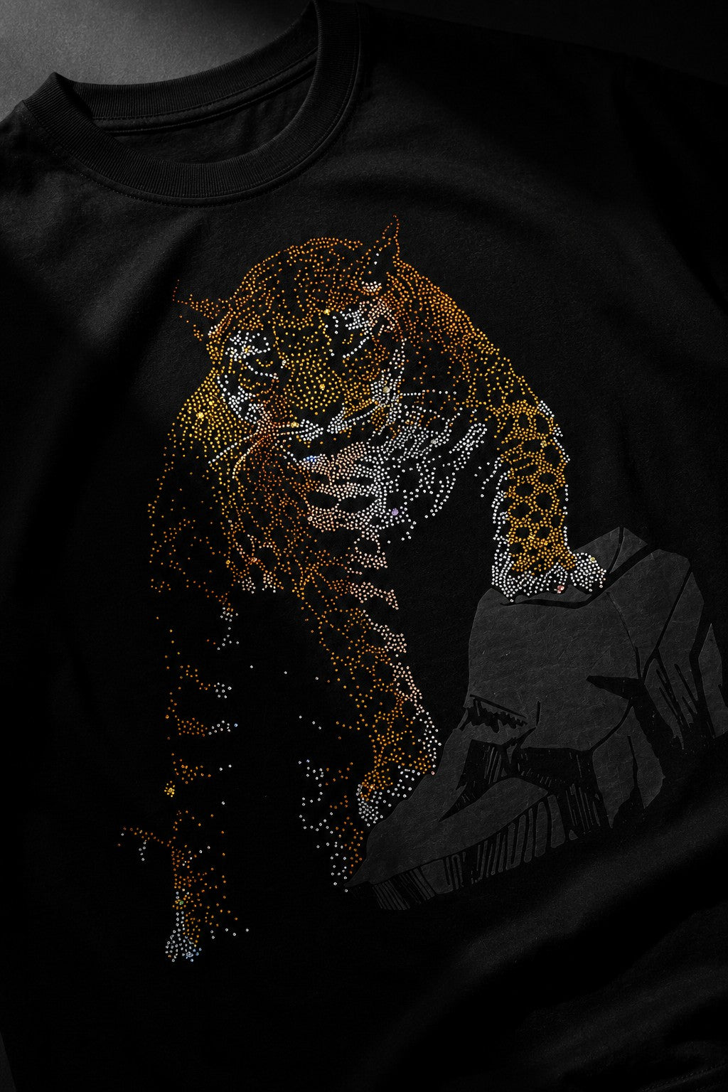 Back view of a man wearing a black UNBREAKABLE TIGER oversized t-shirt, featuring a subtle tonal logo on the upper back. Streetwear aesthetic.