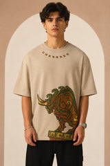 Unbroken Design oversized t-shirt in a beige hue featuring a detailed, stylized brown and green bull graphic print and "UNBROKEN" text across the chest. Showcases ribbed neckline.
