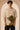 Unbroken Design oversized t-shirt in a beige hue featuring a detailed, stylized brown and green bull graphic print and "UNBROKEN" text across the chest. Showcases ribbed neckline.
