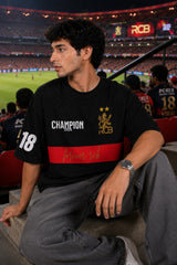Black oversized t-shirt with RCB Champion 2026 gold lion crest forever rcb red stripe and number 18 on sleeve 220 GSM DTF